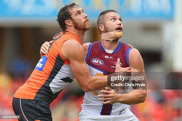 Shane Mumford of the Giants and Stefan Martin of the Lions compete for the ball during the NAB Challenge AFL match between the Brisbane Lions and the...