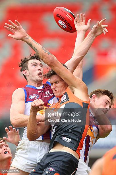 Daniel McStay of the Lions and Cian Hanley of the Giants compete fr the mark during the NAB Challenge AFL match between the Brisbane Lions and the...