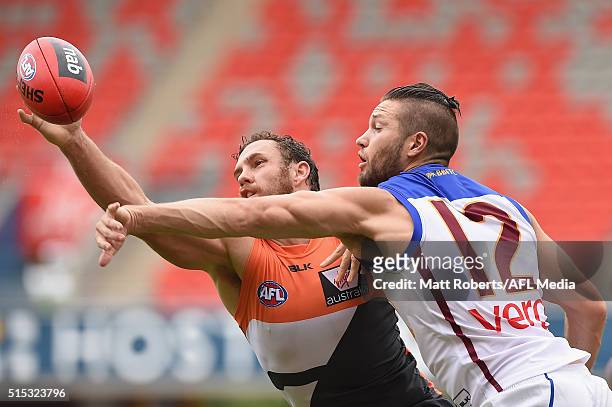 Shane Mumford of the Giants competes for the ball against Stefan Martin of the Lion during the NAB Challenge AFL match between the Brisbane Lions and...