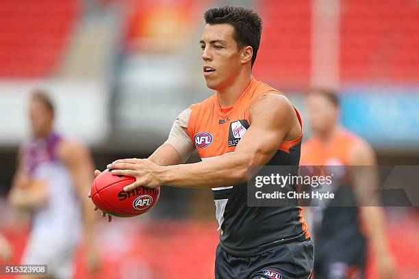 Dylan Shield of the Giants handballs during the NAB Challenge AFL match between the Brisbane Lions and the Greater Western Sydney Giants at Metricon...