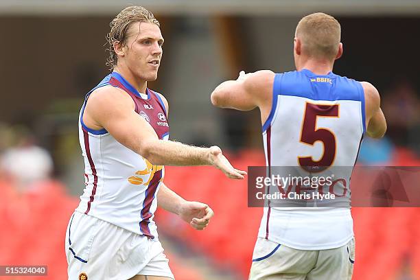 Tom Bell of the Lions celebrates after kicking a goal during the NAB Challenge AFL match between the Brisbane Lions and the Greater Western Sydney...