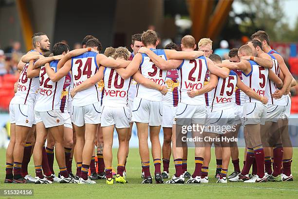 Lions team huddle during the NAB Challenge AFL match between the Brisbane Lions and the Greater Western Sydney Giants at Metricon Stadium on March...