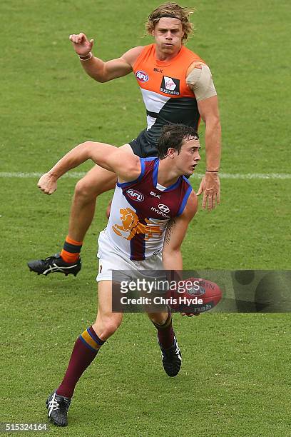 Lewis Taylor of the Lions handballs during the NAB Challenge AFL match between the Brisbane Lions and the Greater Western Sydney Giants at Metricon...