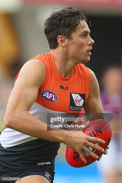 Josh Kelly of the Giants runs the ball during the NAB Challenge AFL match between the Brisbane Lions and the Greater Western Sydney Giants at...