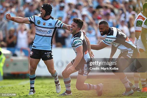 Michael Ennis, Chad Townsend and Jayson Bukuya of the Sharks celebrate Townsend scoring a try during the round two NRL match between the Cronulla...