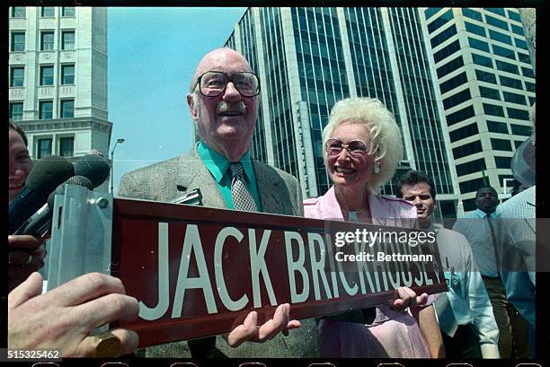 Jack Brickhouse, Chicago sportscaster who has announced White sox and cubs games for many years, and his wife, Pat, hold a sign with his name at the...