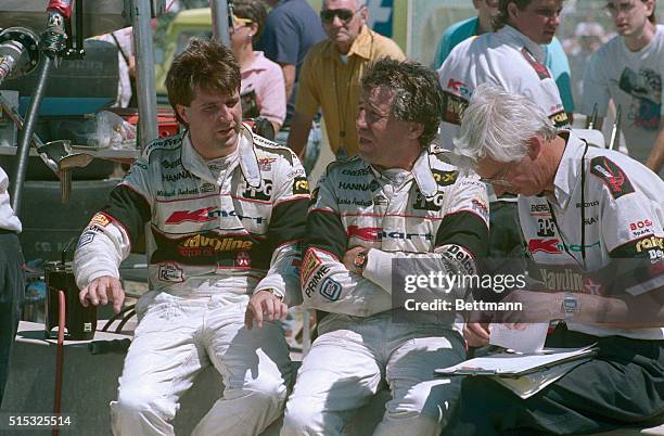 Michael Andretti winner of todays pole position at the Cleveland Grand Prix with a speed of 137 mph talks to his teammate and father Mario Andretti...