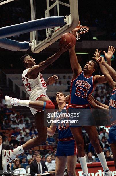 East Rutherford N.J.: Roy Hinson , of the N.J. Nets, drives for the basket, only to have his shot blocked by James Edwards of the Detroit Pistons...