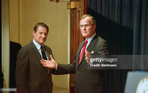 Washington: CIA Director William Webster holds the door for President Elect George Bush after a news conference in the Old Executive Office Building....