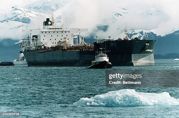 Prince William Sound, AK- The tanker Exxon Valdez is pulled across Prince William Sound by a tug boat, past floating ice, after having been freed...
