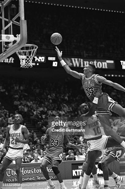 Chicago Bulls' Scottie Pippen sails in for a layup over Rockets' Purvis Short in the first quarter of the Rockets-Bulls game. Bulls' Michael Jordan...