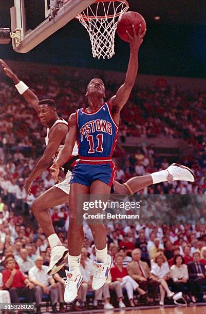 Portland: Detroit Pistons' Isaiah Thomas scores as a flying Portland Trail Blazers' Jerome Kersey tries to defend in the 1st quarter of their NBA...