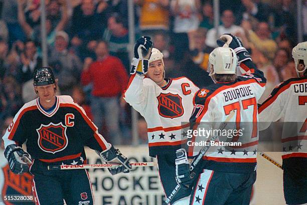 Pittsburgh's Mario Lemieux celebrates his first period goal for the Wales Conference with teammate Ray Bourque as long time Campbell Conference star...