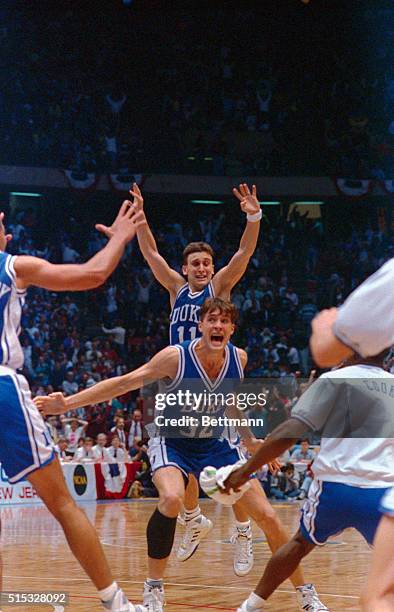 Christian Laettner of Duke Blue Devils yells out his jubilation after scoring the winning overtime basket against Connecticut Huskies. Teammate Bobby...