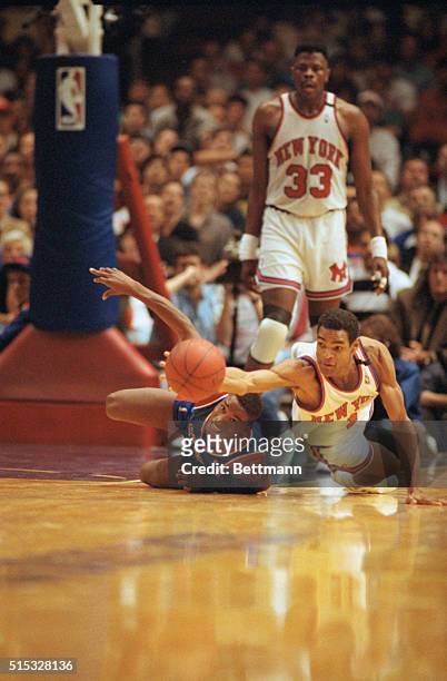 New York: Knicks' Maurice Cheeks gets his hand on a loose ball while the Piston's Isiah Thomas struggles after it during semifinal at Madison Square...