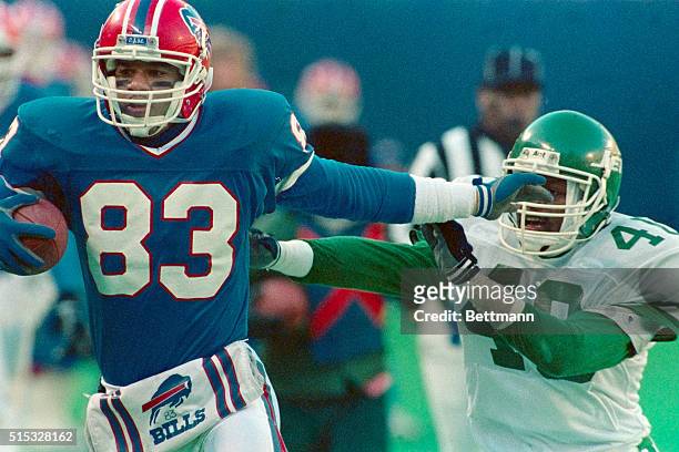 Bills' Andre Reed uses his arm to get away from Jets' James Hasty after catching a pass from QB Jim Kelly in the third quarter at Giants Stadium. The...