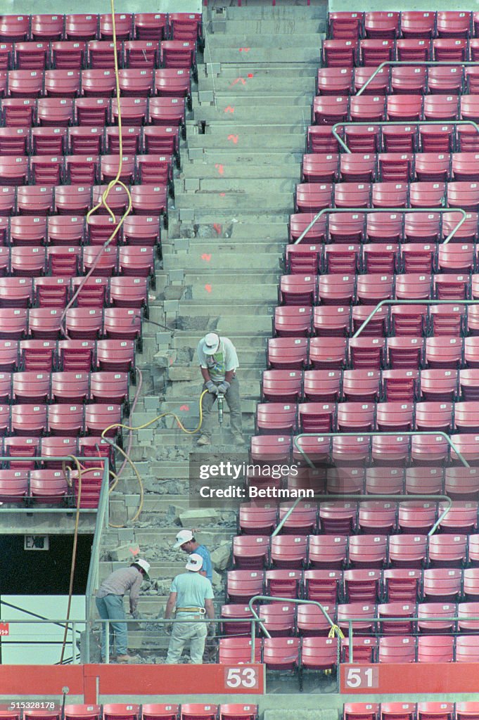 Workers Repairing Earthquake Damaged Baseball Park