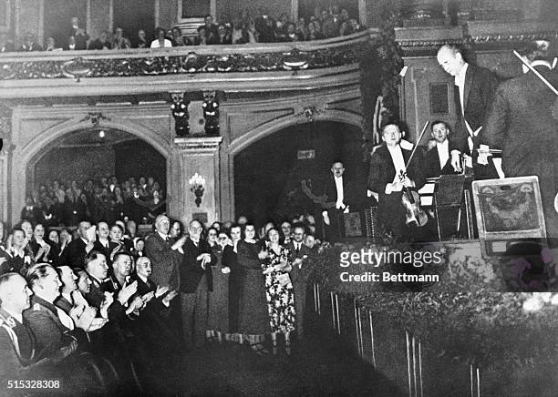 This photo, taken while Nazis were powerful in Germany, shows Wilhelm Furtwaengler acknowledging applause of audience after concert by Berlin...