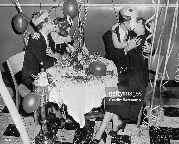 Paying lip service to the New Year are these couples at Tavern on the Green, where they said farewell to 1948, New Year's Eve. Don't let drinks fool...