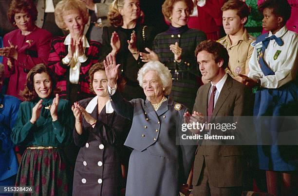 Washington: First Lady Barbara Bush waves to her husband before he addressed a joint session of Congress 2/9. Mrs. Bush is flanked by her son,...