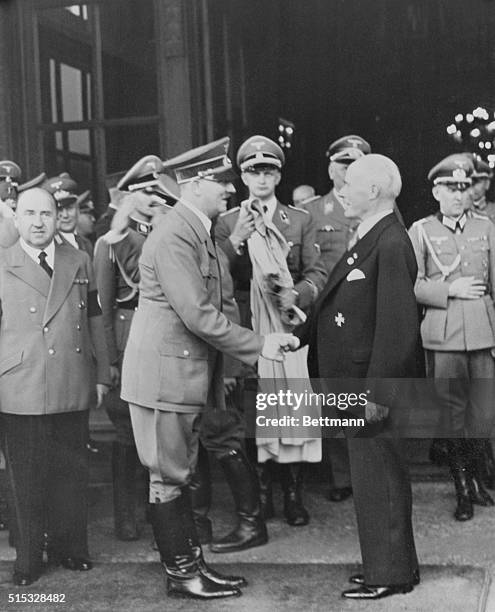 Berlin, Germany: Merchants Of Death In Mutual Admiration. Reichsfuehrer Adolf Hitler, high priest of the blitzkrieg shown congratulating Dr. Krupp...