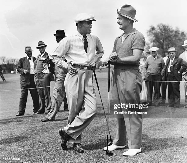 Ben Hogan and Jimmy Demaret are shown discussing prospects of upsets during a practice round in preparation for the opening of the Masters' golf...