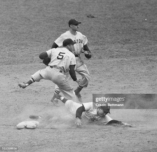 Yank Yogi Berra is erased at second on Joe DiMaggio's grounder to Boston's Bobby Doerr in the eight frame of the crucial Yanks-Red Sox game at Yankee...