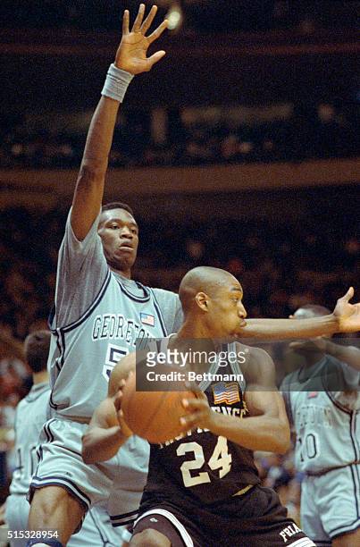 Marques Bragg of the Providence Friars has no where to go as 7'2" Dikembe Mutombo of Georgetown covers him during first half action at Madison Square...