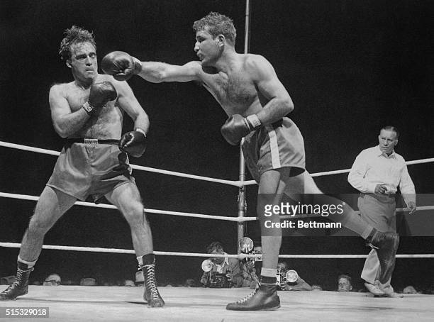 Marcel Cerdan of France backs just out of reach of Jake LaMotta's left early in the middleweight title fight in Detroit June 16. LaMotta took the...