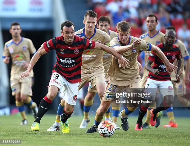 Mark Bridge of the Wanderers contests the ball with Lachlan Jackson of the Jets during the round 23 A-League match between the Newcastle Jets and the...