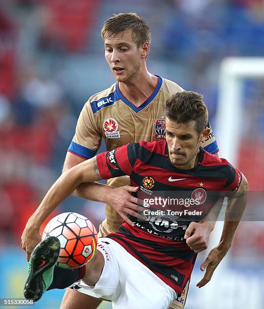 Dario Vidosic of the Wanderers contests the ball with Lachlan Jackson of the Jets during the round 23 A-League match between the Newcastle Jets and...