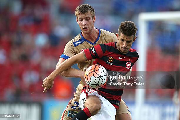 Dario Vidosic of the Wanderers contests the ball with Lachlan Jackson of the Jets during the round 23 A-League match between the Newcastle Jets and...