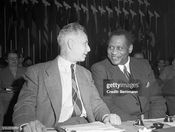 The American Negro singer Paul Robeson is shown after his arrival for the World Congress of the Partisans of Peace, as , he talks with French...