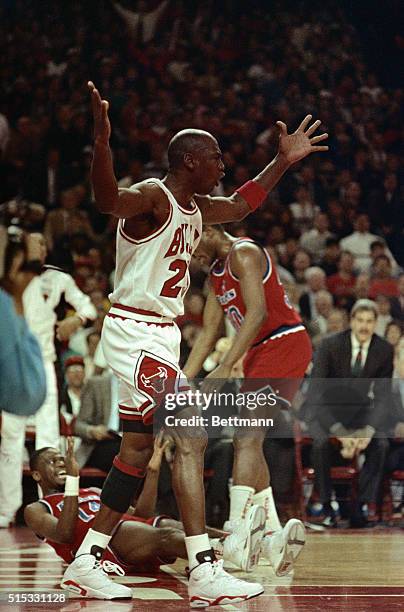 Bulls' Michael Jordan shows his emotions at the official after he was called for a foul trying to block a shot by Bullets' A.J. English during the...