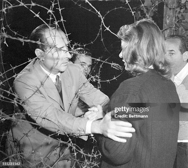 Rossellini Directs Bergman. The director gently places his star in position outside the barbed wire enclosure in which her husband, played by Mario...