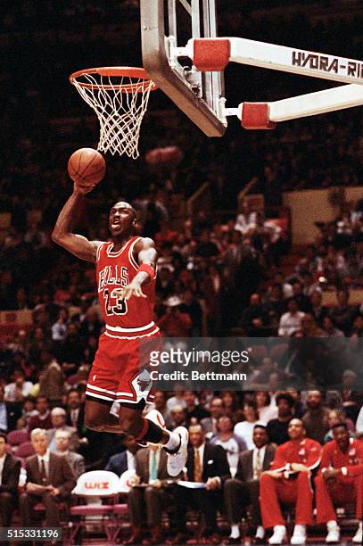 Chicago Bulls' Michael Jordan stuffs the basketball through the basket as the Knicks' Maurice Cheeks watches helplessly as Madison Square Garden 2/14.
