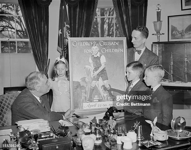 President Franklin D. Roosevelt receiving the original painting for a poster, created by artist Norman Rockwell, for the Children's Crusade for...