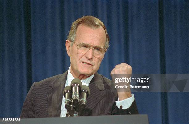 Washington: Appearing at a press briefing, President Bush gestures with his fist. The president said a conflict with Iraq would not turn into another...