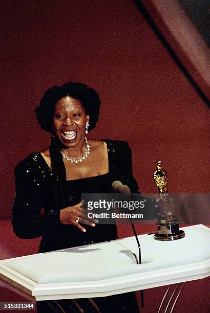 Los Angeles: Whoopi Goldberg holds her Best Supporting Actress Oscar for her role in Ghost March 25.
