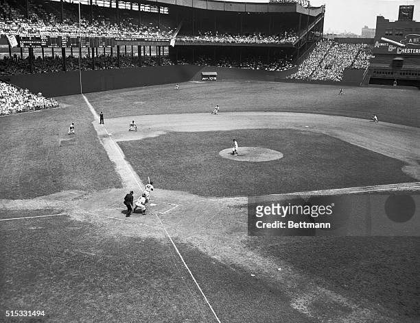 Jackie Robinson bats out a line drive his 100th hit to pitcher Clint Hartung of the Giants in the game at the Polo Grounds between New York and...