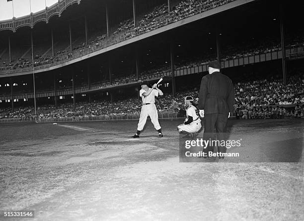 Yankee Clipper Joe DiMaggio cocks the wood during the home run hitting contest that preceded the night Yankee-Giants exhibition game at Yankee...