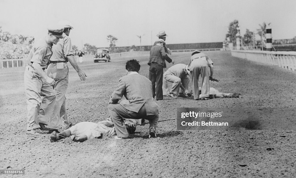 Hurt Jockeys Lying on the Ground