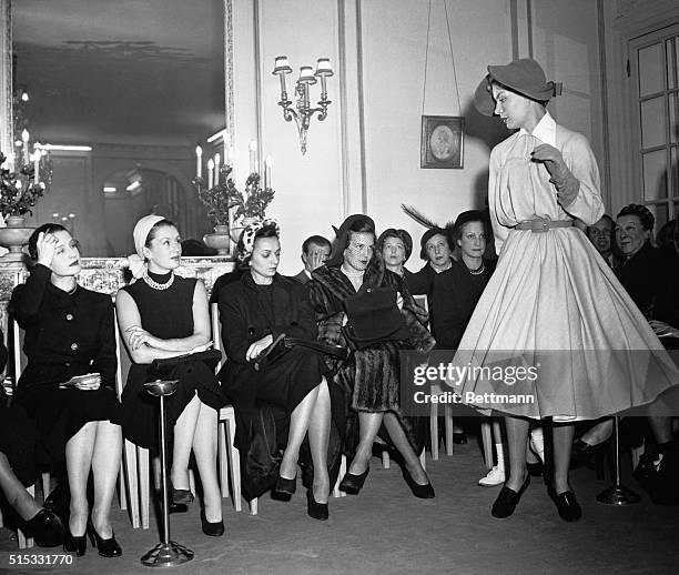 Royal and Hollywood expressions greet this new Jacque Fath creation at a Paris fashion show, as movie star, Norma Shearer, and princess De Rethy,...