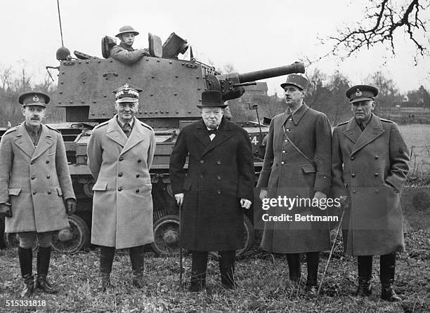 General Wladyslaw Sikorski of Poland, Prime Minister Winston Churchill, and General Charles de Gaulle of France gather with other officers for a tank...