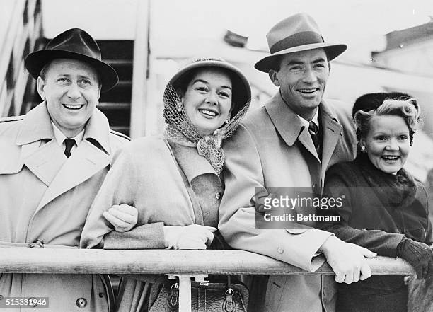 Arriving in Southampton, England aboard the Queen Elizabeth are from left: Movie producer Fred Brisson and his wife American actress Rosalind Russell...