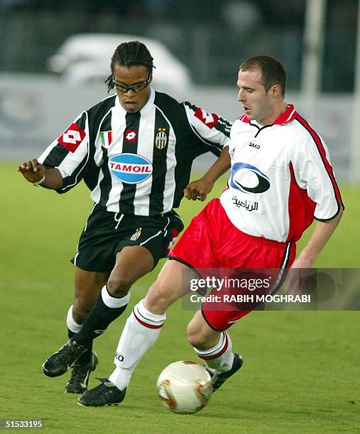 Duch midfielder Edgar Davids of Juventus fights for the ball with Bulent Kormaz of the All Stars team during the testimonial match of United Arab...