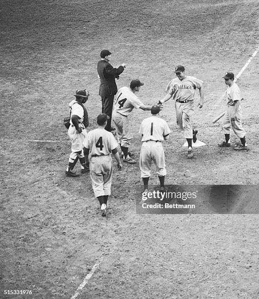 Philadelphia's Dick Sisler trots home in the top of the tenth inning of the game against Brooklyn, Oct.1, and teammate Del Ennis steps up to make...