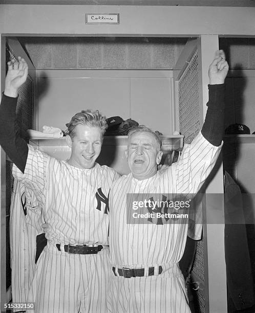 New York Yankees' manager Casey Stengel claps his winning pitcher Whitey Ford on the back, after the Yanks' fourth straight World Series game win...