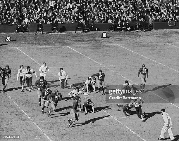 George McAfee, Chicago Bears half-back carries the ball for a short gain in the first period of the National Football League playoff with the...
