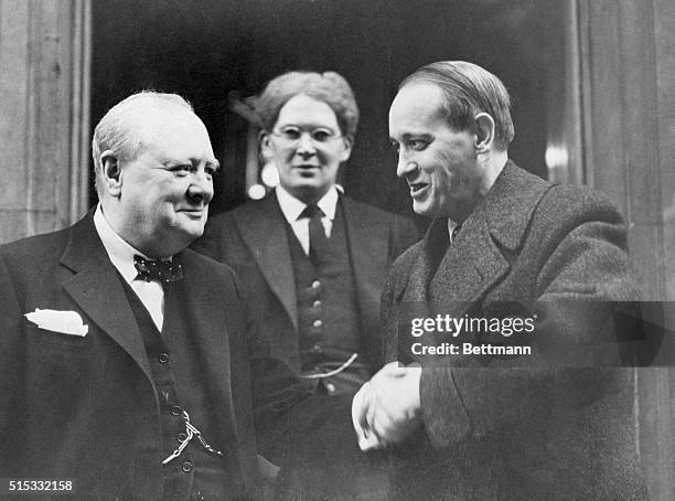 London, England- Harry Hopkins, President Roosevelt's personal representative in England is pictured shaking hands with Prime Minister Winston...